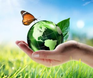 green planet earth in hand with butterfly